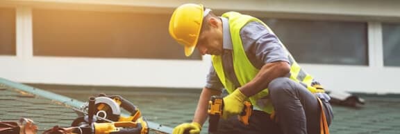 Professional roofing contractor installing new roof shingles